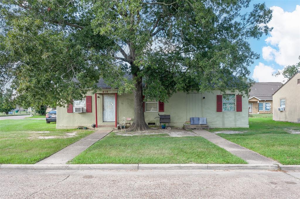 a front view of house with yard and trees