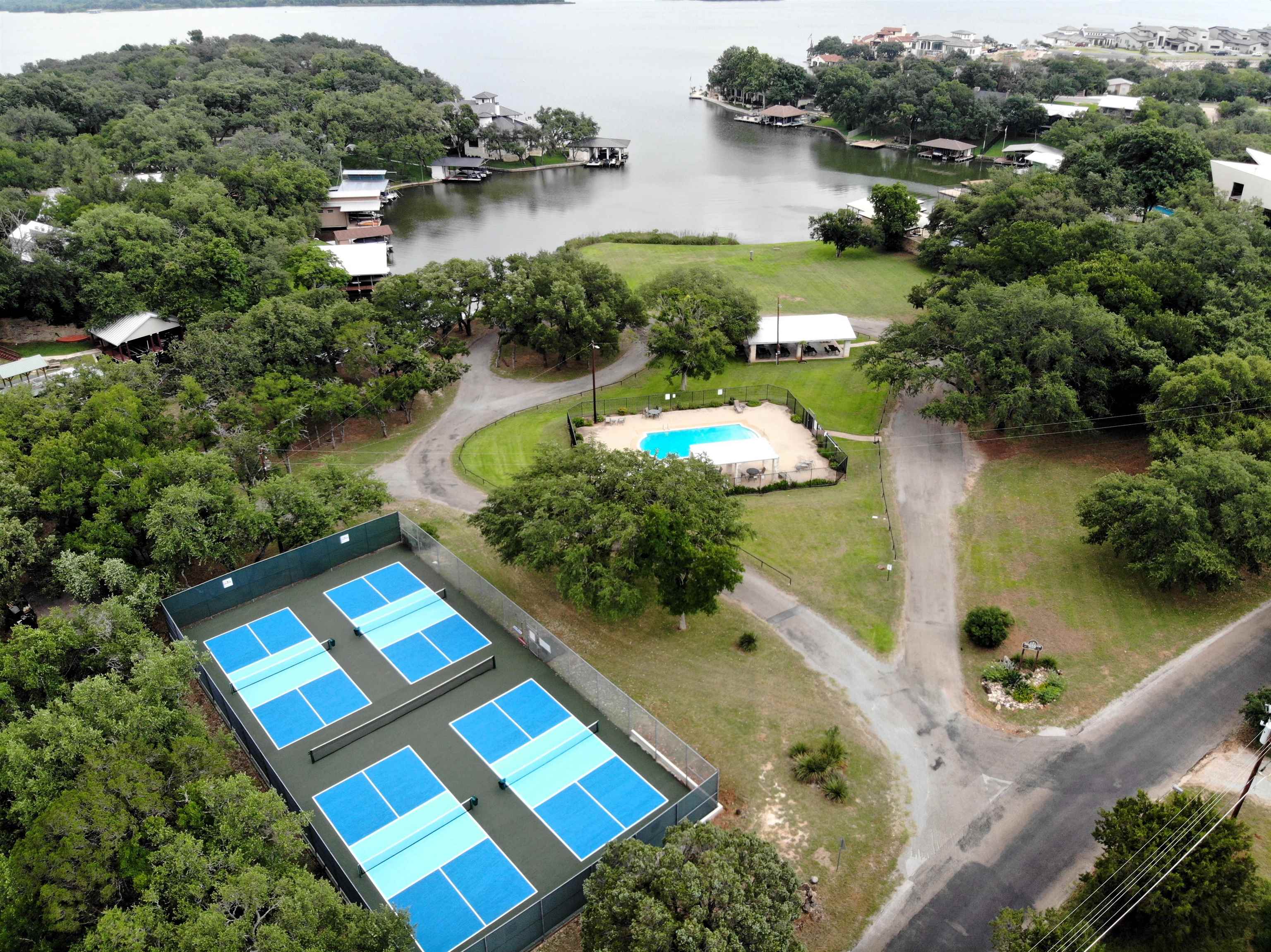 an aerial view of a house with a yard and lake view