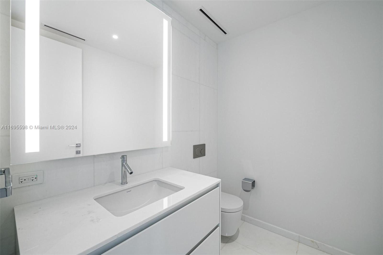 a bathroom with a sink toilet and mirror