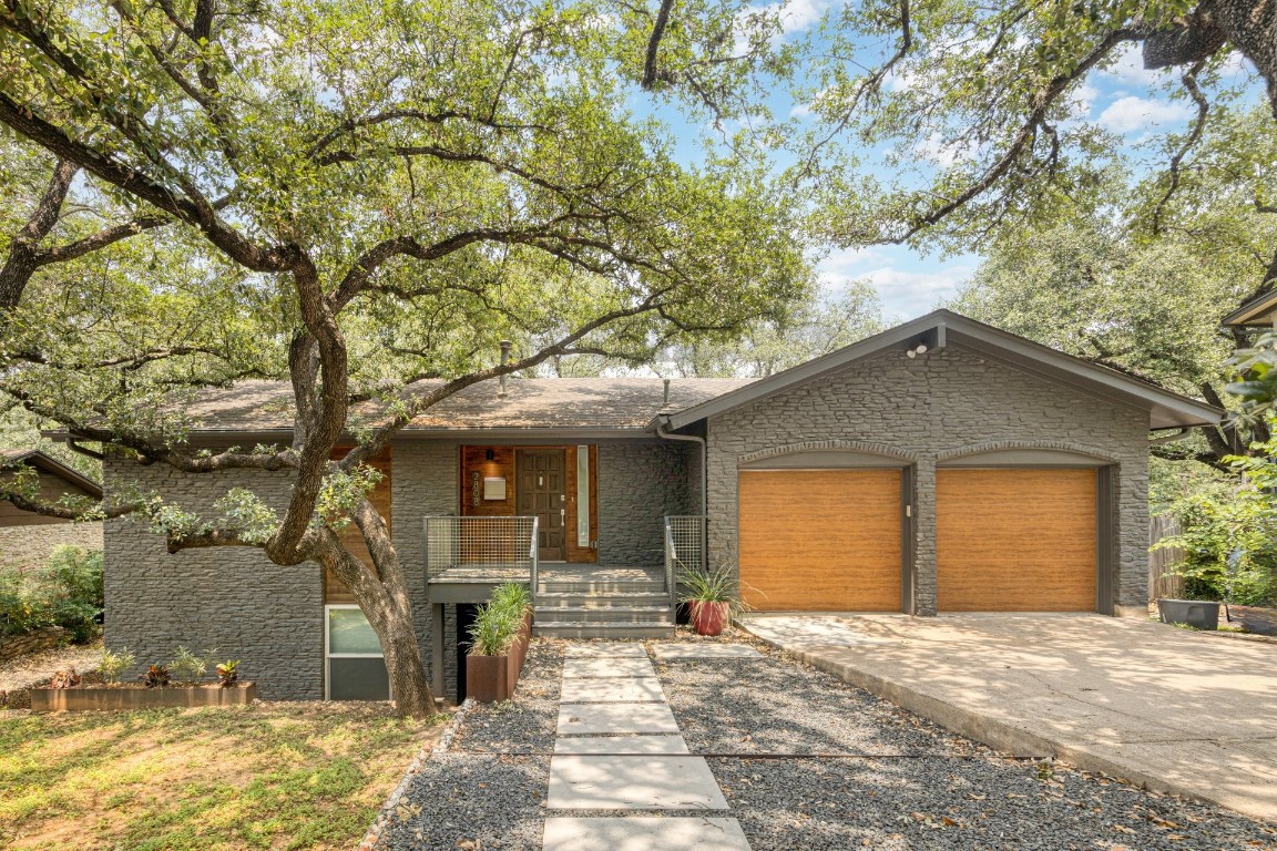 a front view of a house with garden