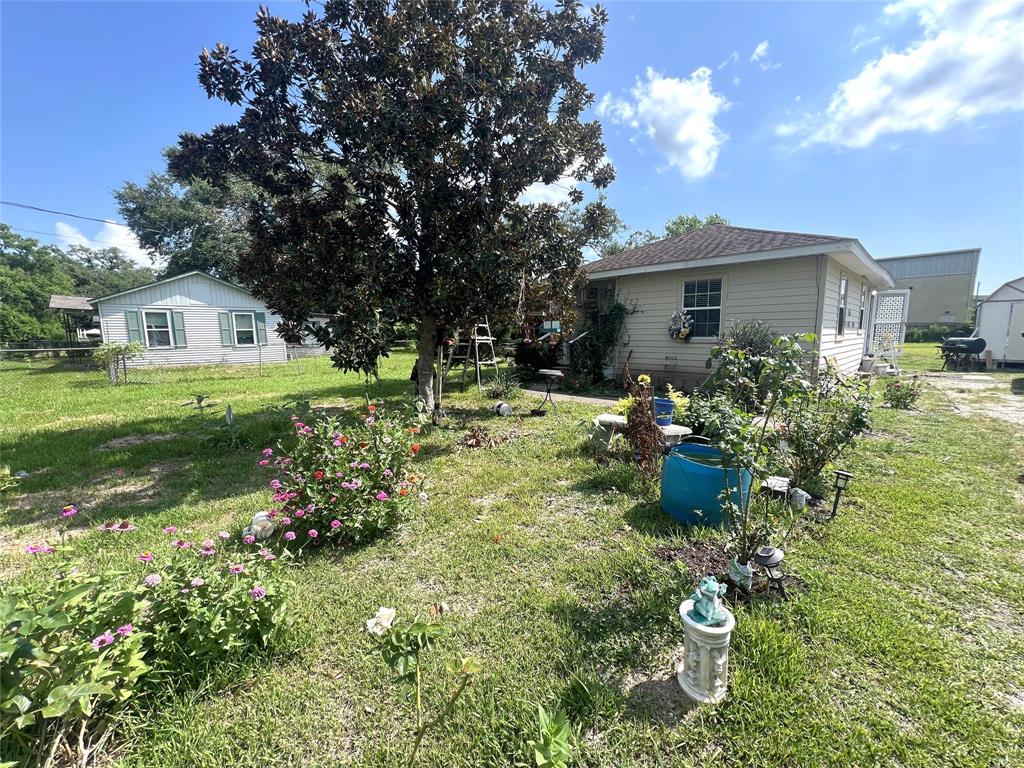 a view of a house with a yard and sitting area