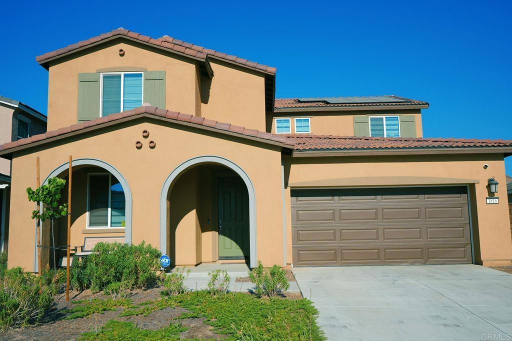 a front view of a house with garage