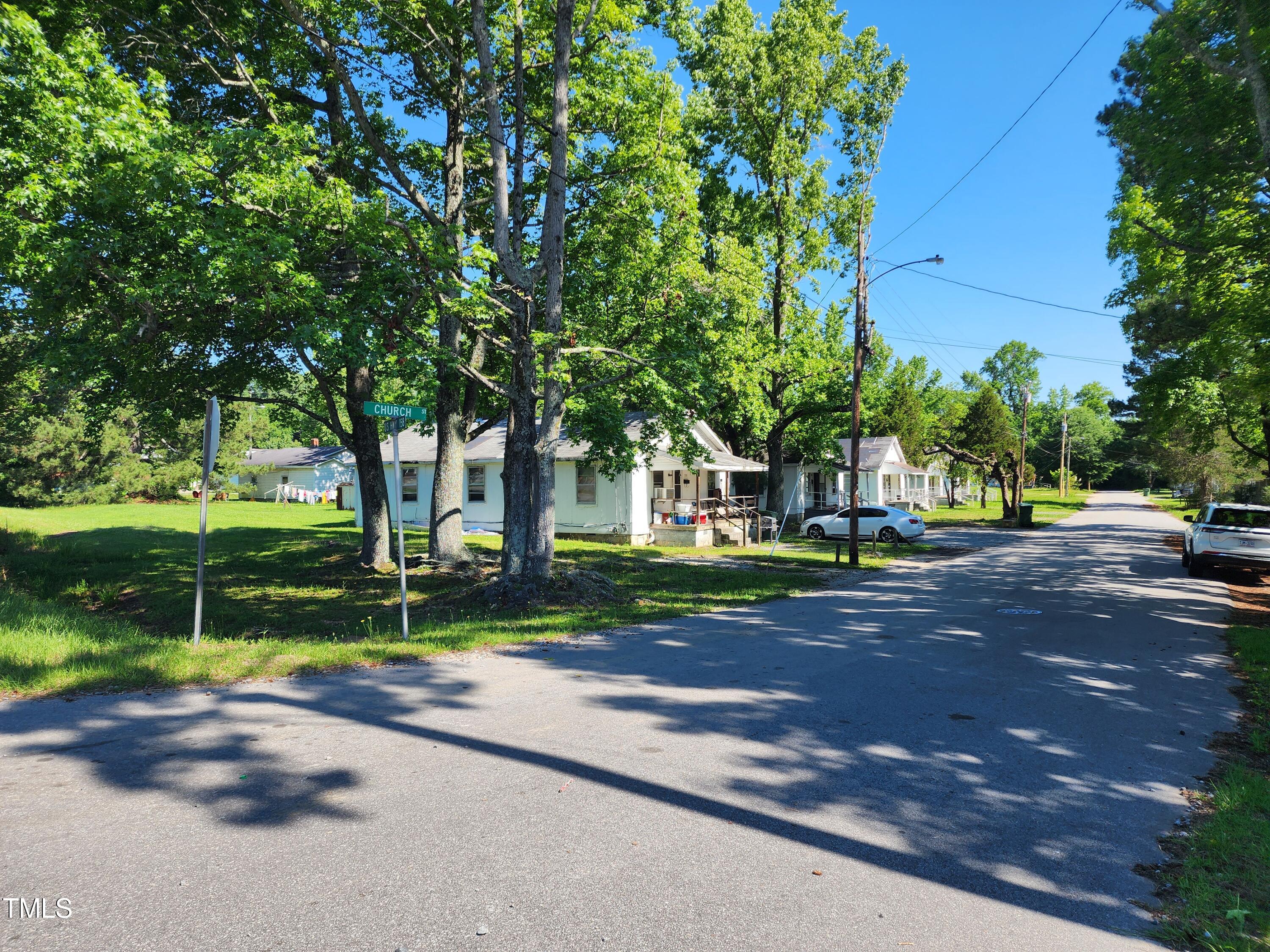 a view of street with houses and trees in the background