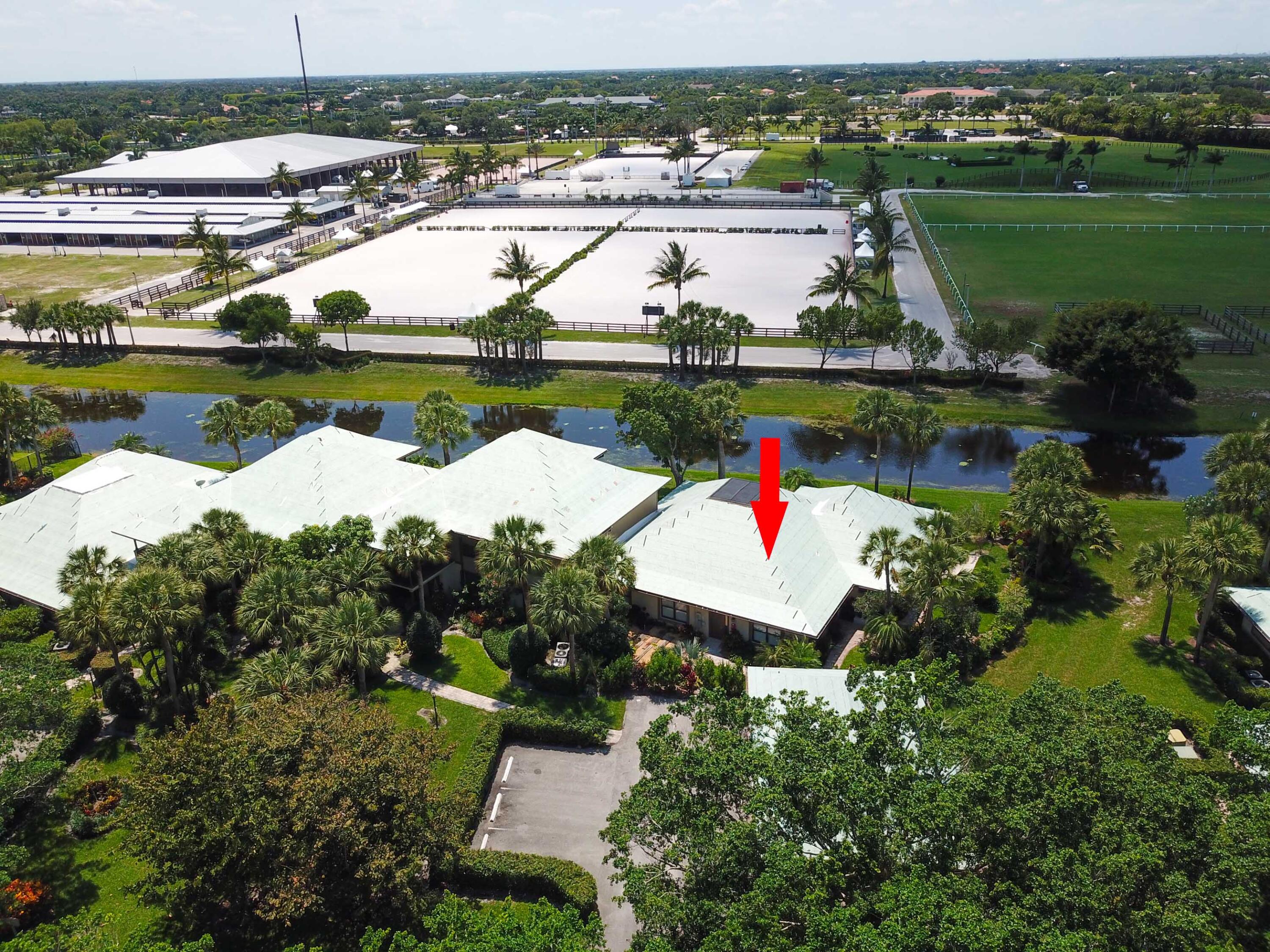 an aerial view of a house with a garden and lake view