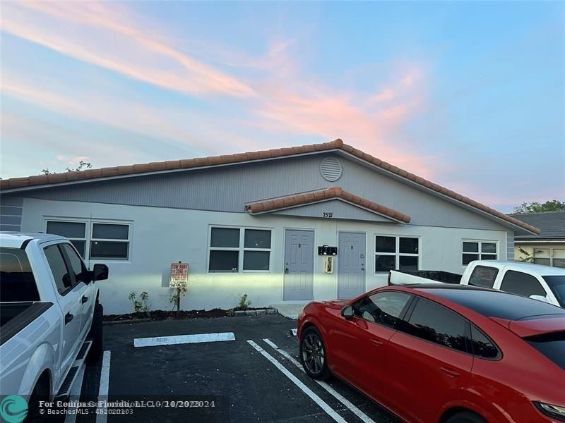 a front view of a house with parking space