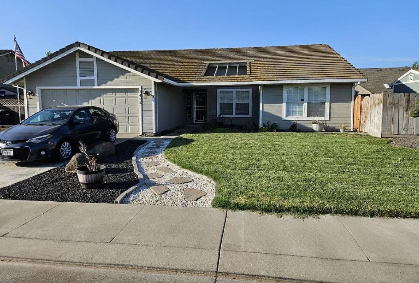 a front view of a house with a garden and porch