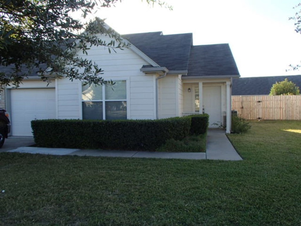 a view of backyard of house and trees