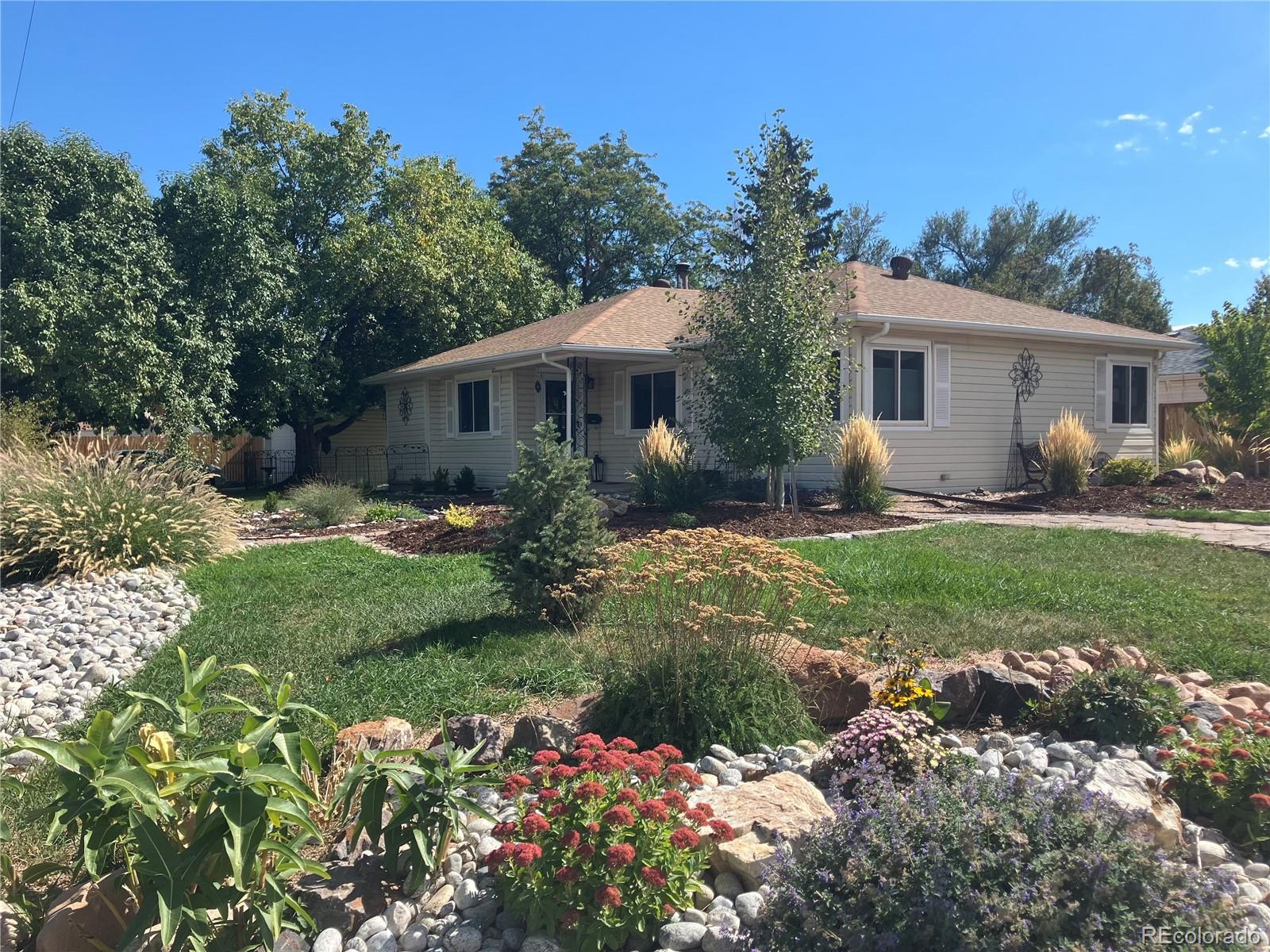 a front view of house with yard and green space