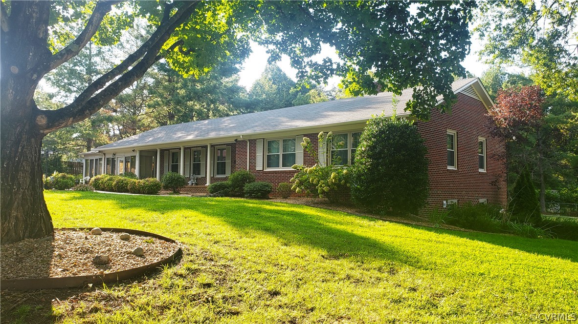 a view of a house with swimming pool and a yard