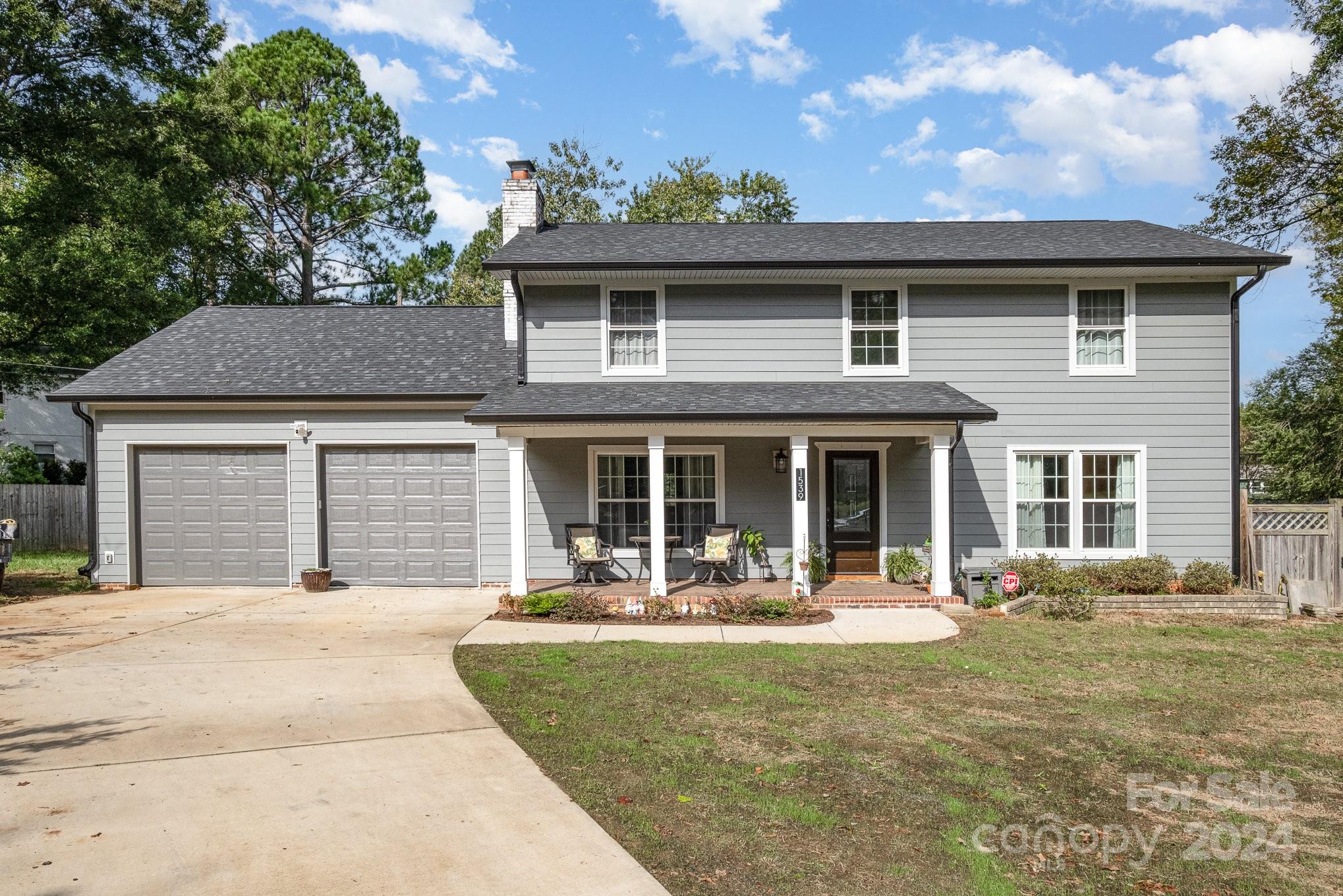 a front view of a house with a yard and outdoor seating