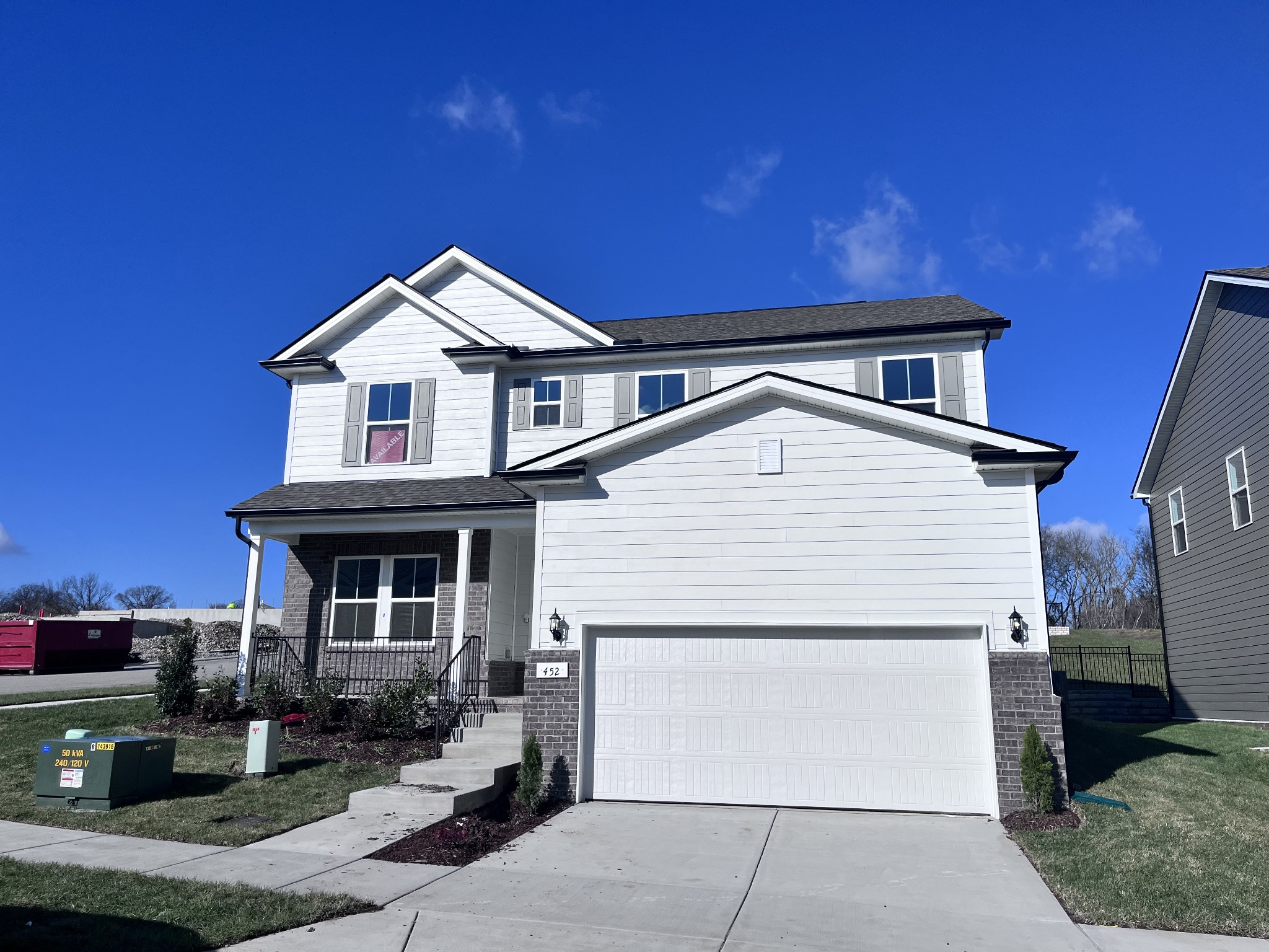 a view of a house with a yard and seating space