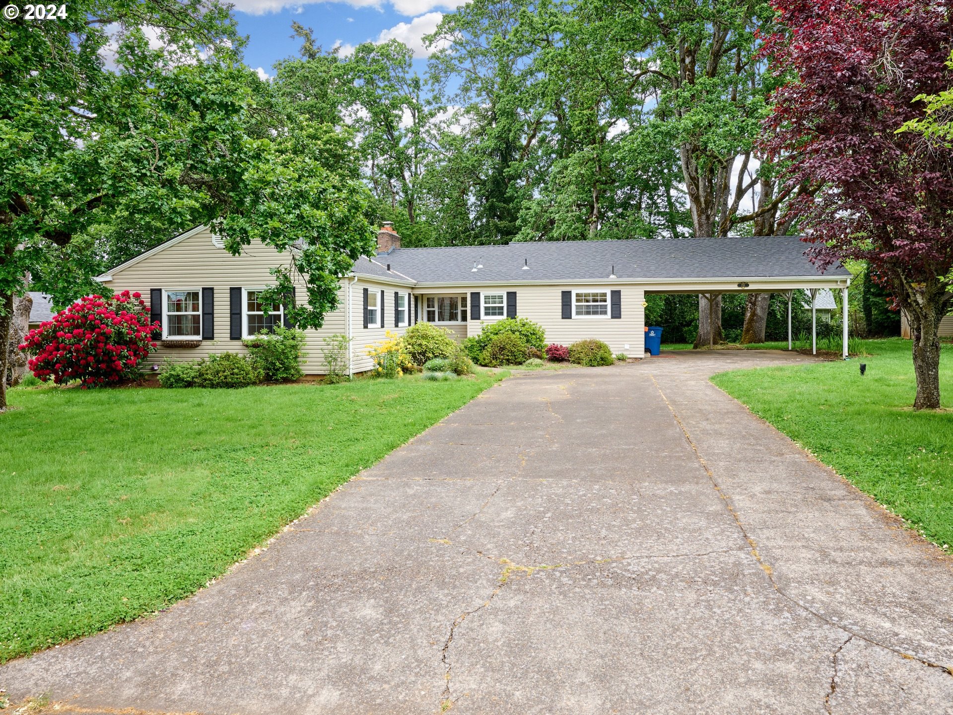 a front view of house with yard and green space