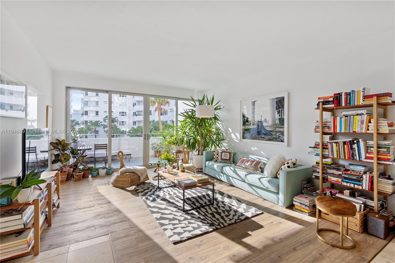 a living room with furniture and a book shelf