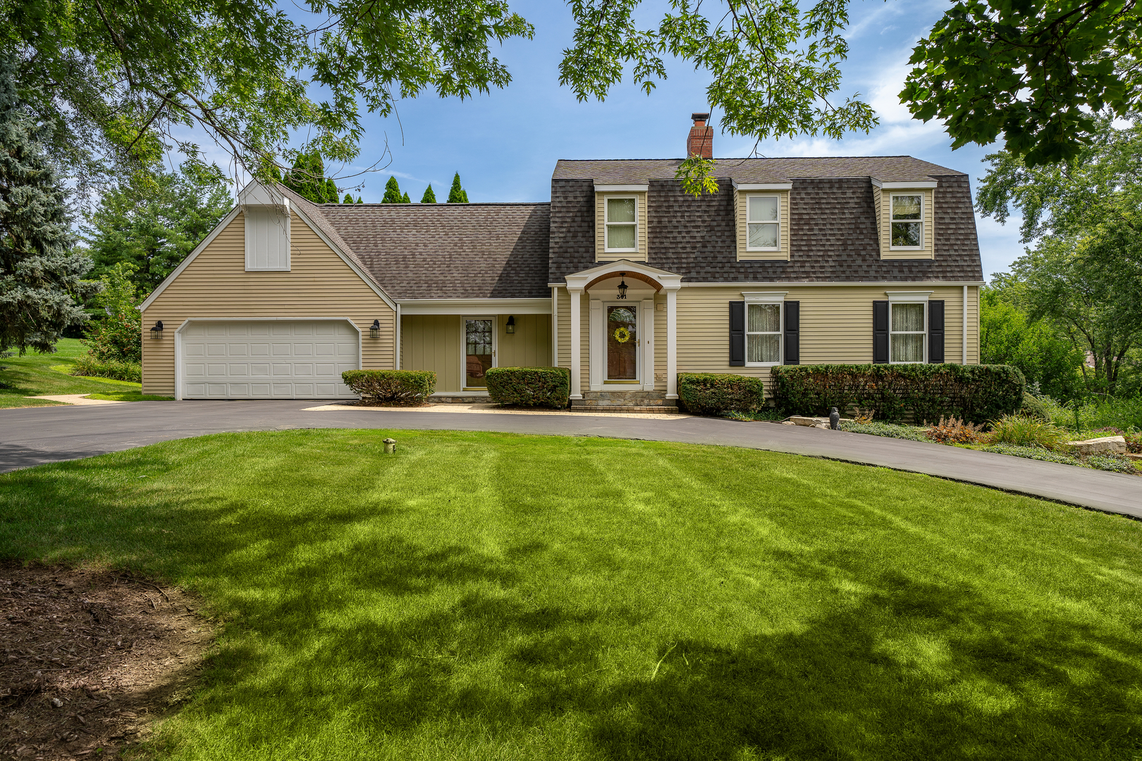 a front view of house with yard and green space