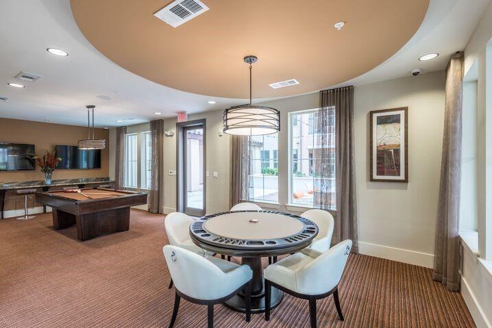 a living room with furniture a table and a chandelier