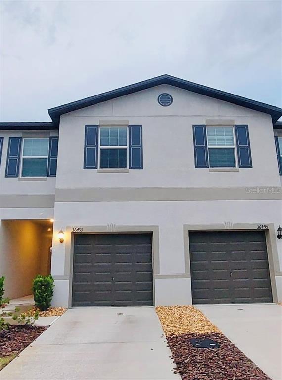 a front view of a house with garage