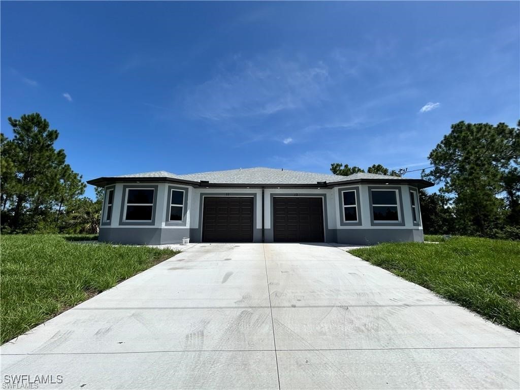 a front view of a house with a yard and garage