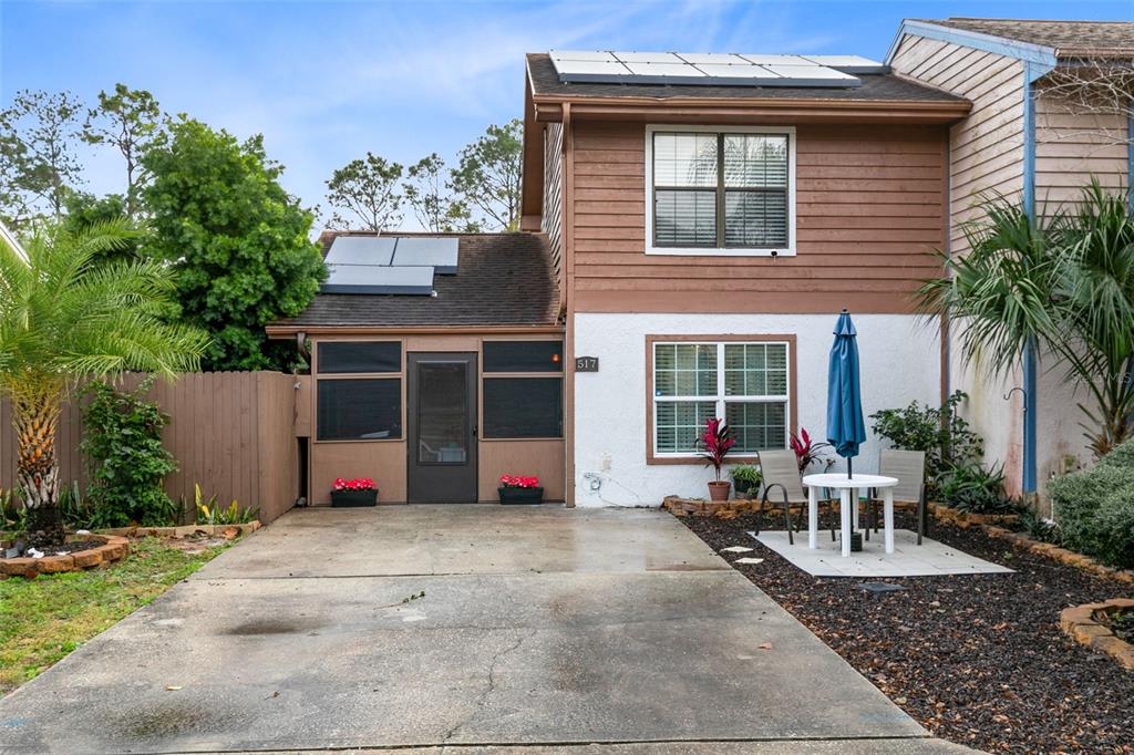 a view of a house with backyard sitting area and garden