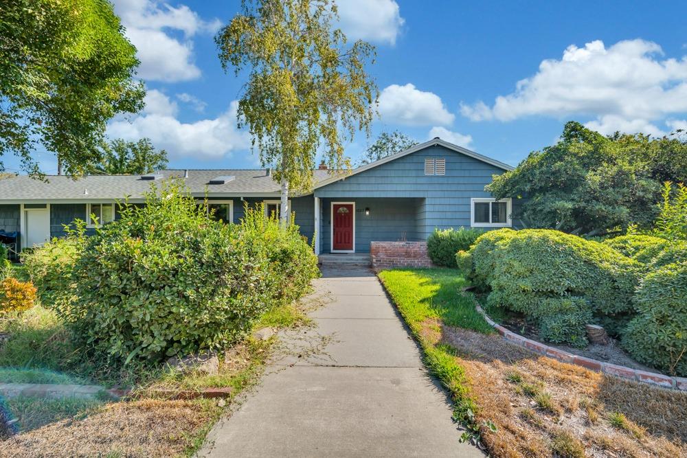 a front view of a house with garden