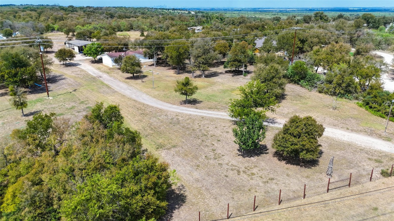 Long drive to the house from the road. Beautiful tree lined lot with mature trees.