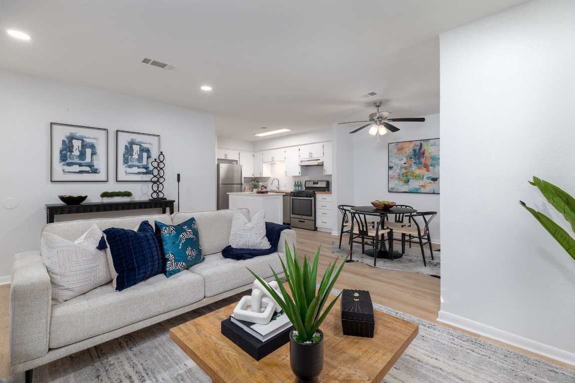 a living room with furniture and a wooden floor