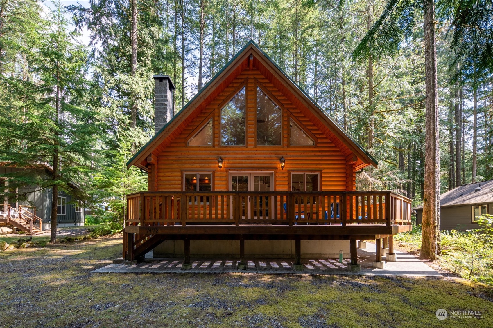 a view of a house with a yard deck and a garden