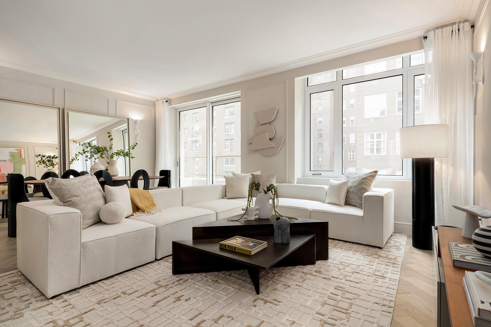 a living room with furniture large window and a flat screen tv