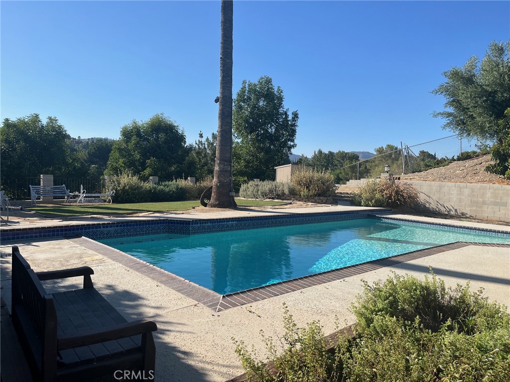 a view of a swimming pool with a yard