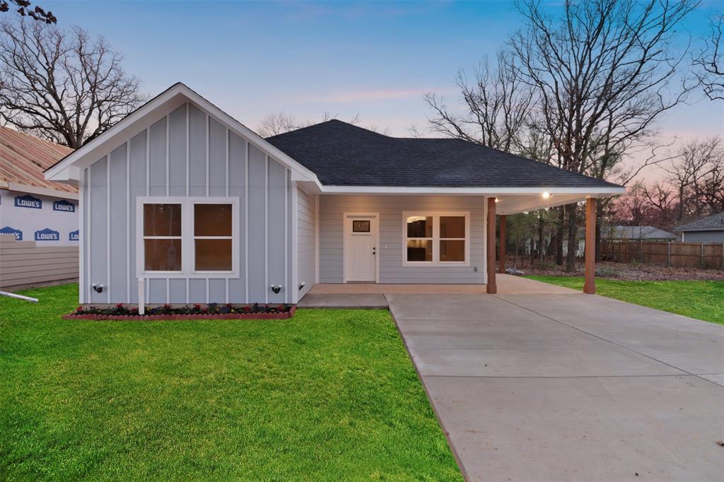 Ranch-style home featuring a lawn