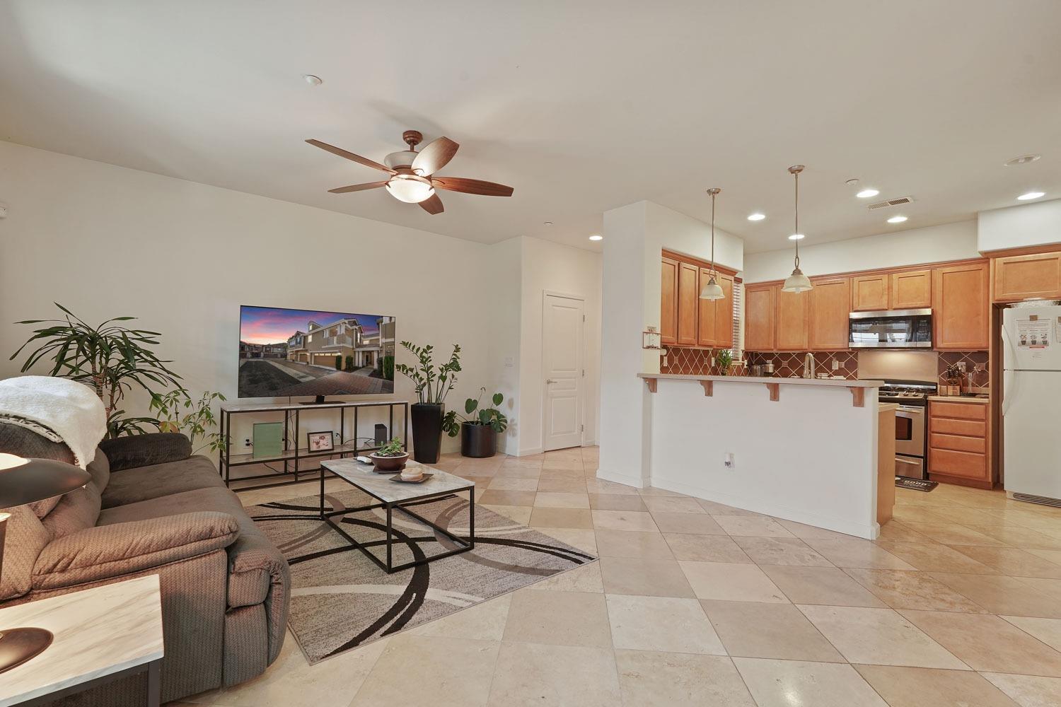 a living room with furniture and kitchen view