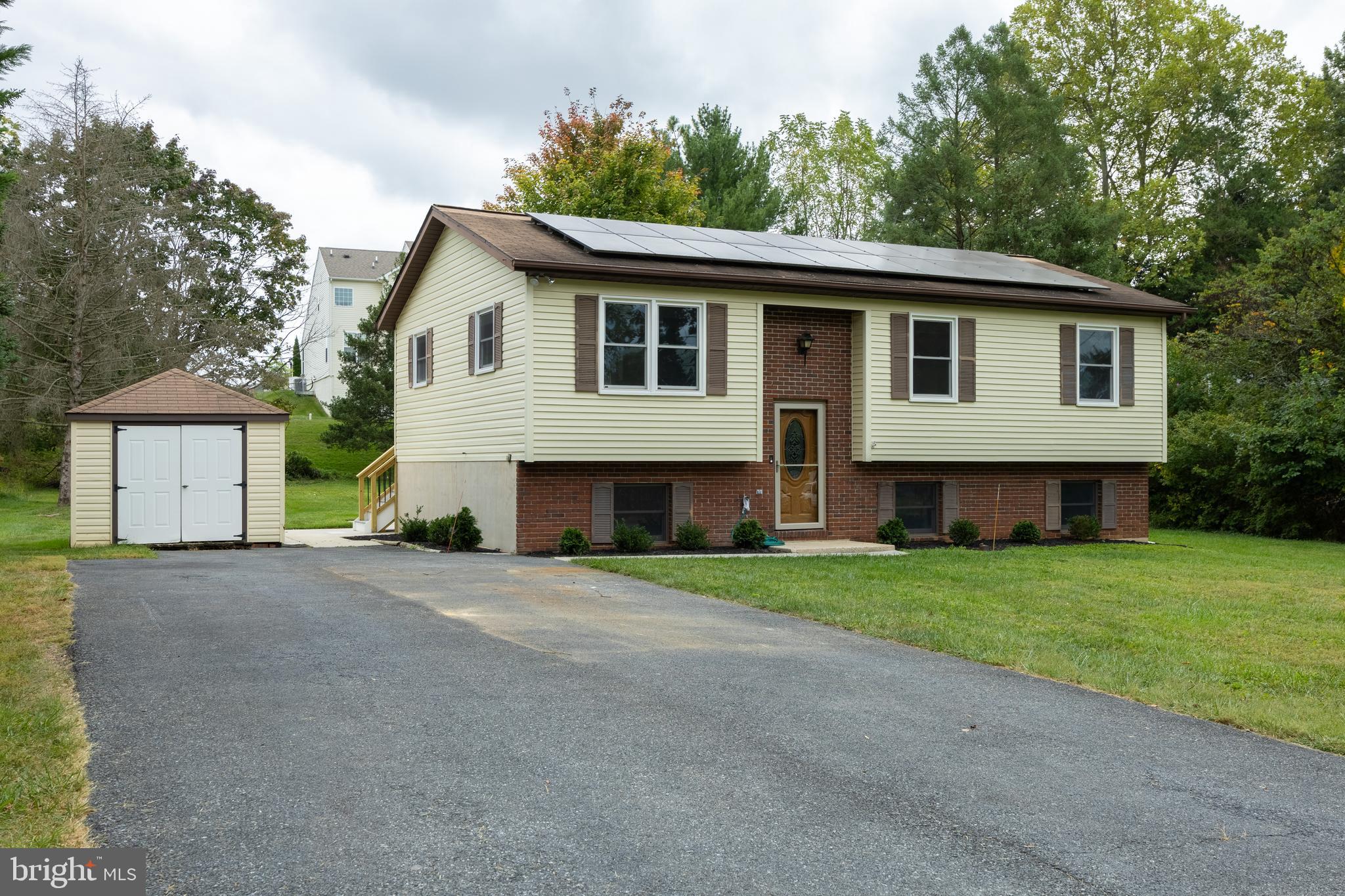 a front view of a house with a garden and yard