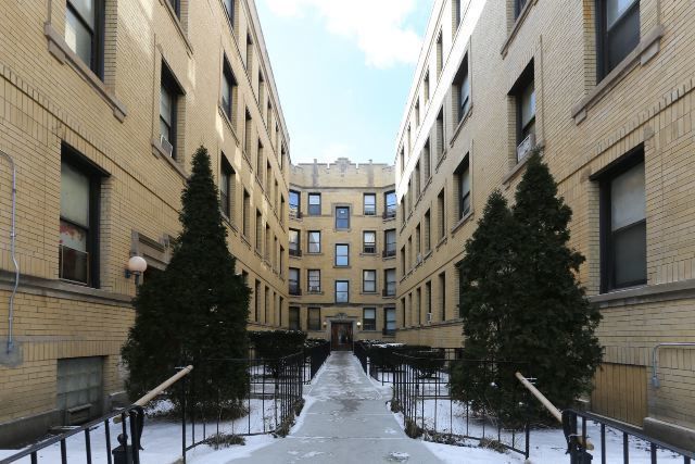 a view of buildings with yard