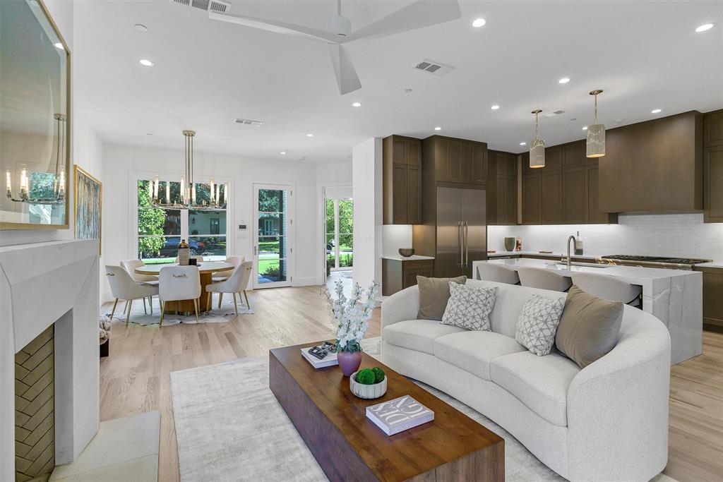 a living room with furniture kitchen and a table