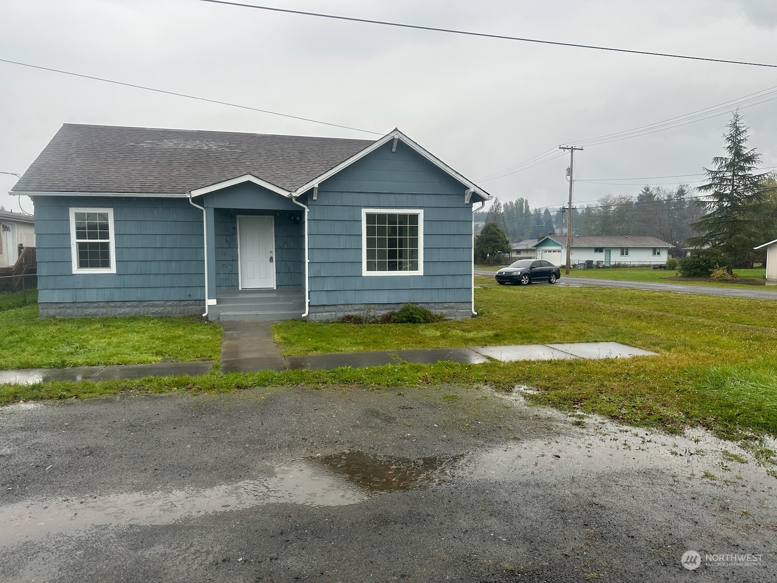 a view of a house with a yard and a garage