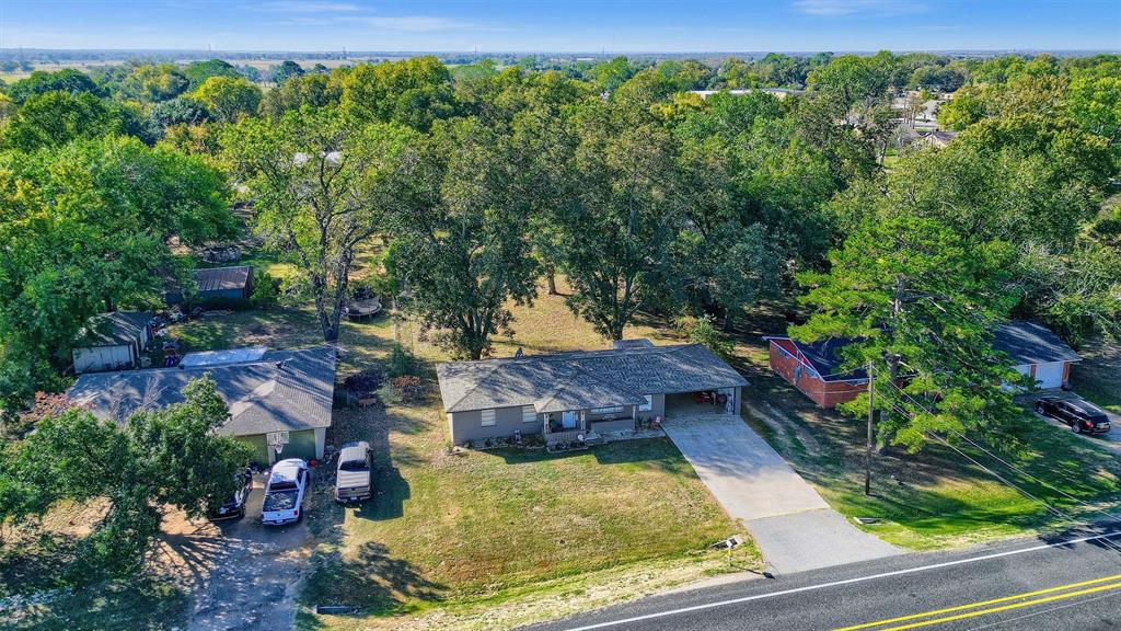 an aerial view of a house with a yard basket ball court and outdoor seating