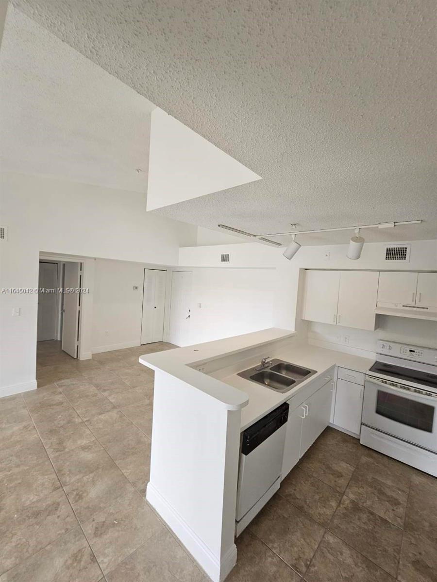 a kitchen that has a sink and cabinets