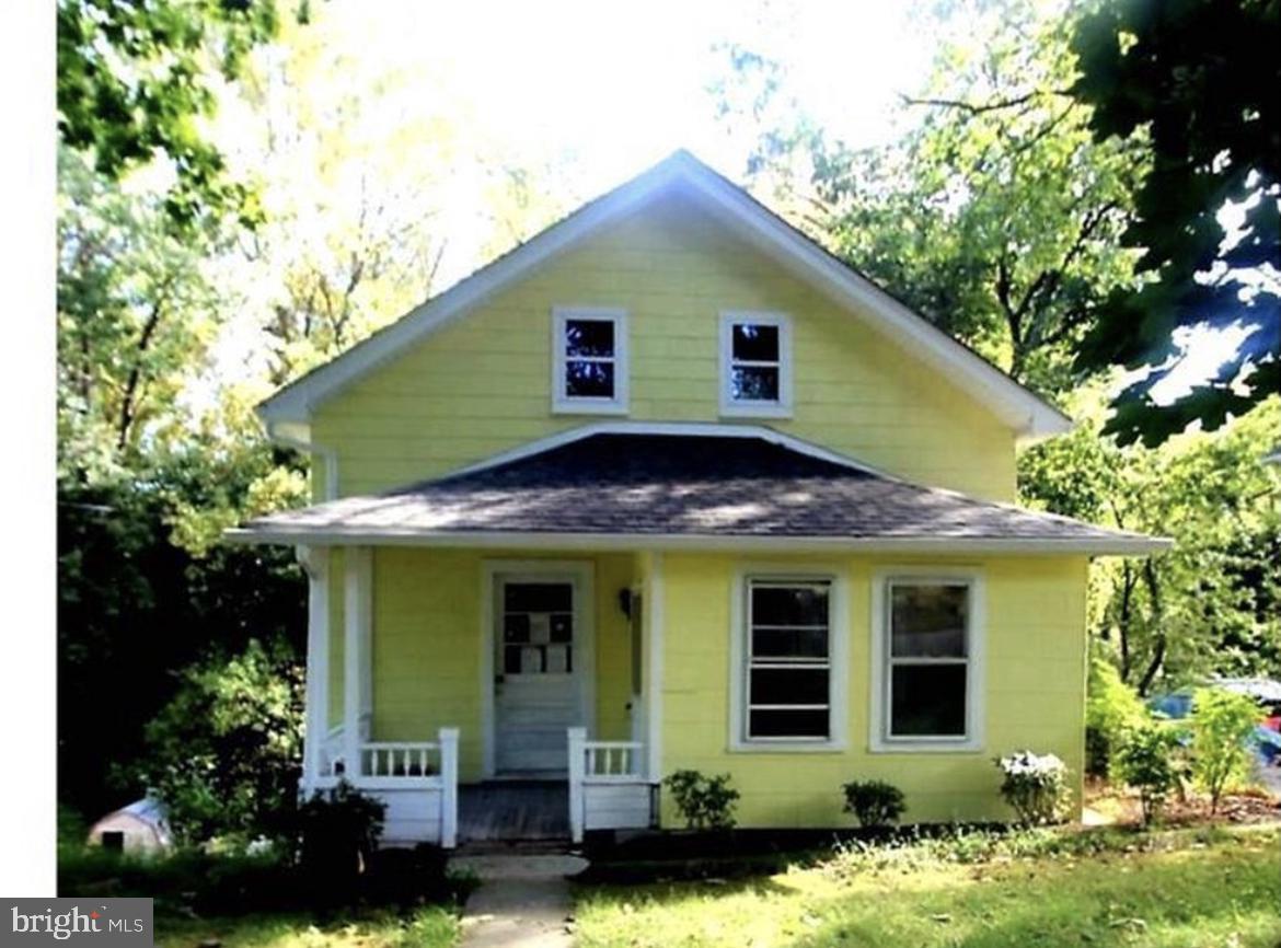 a view of a house with potted plants and a table