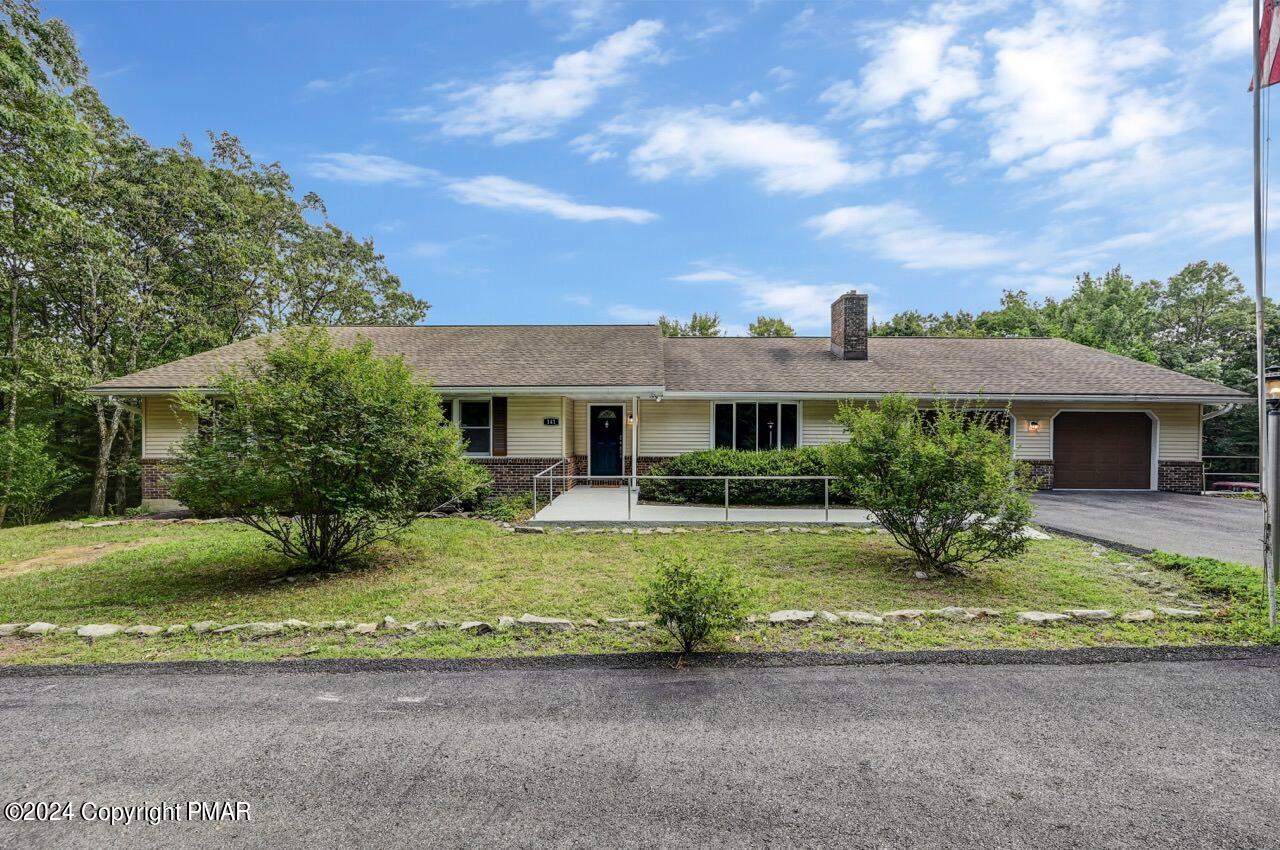 a front view of a house with garden