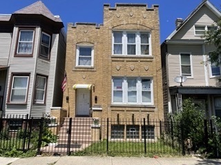 front view of a brick house with a street