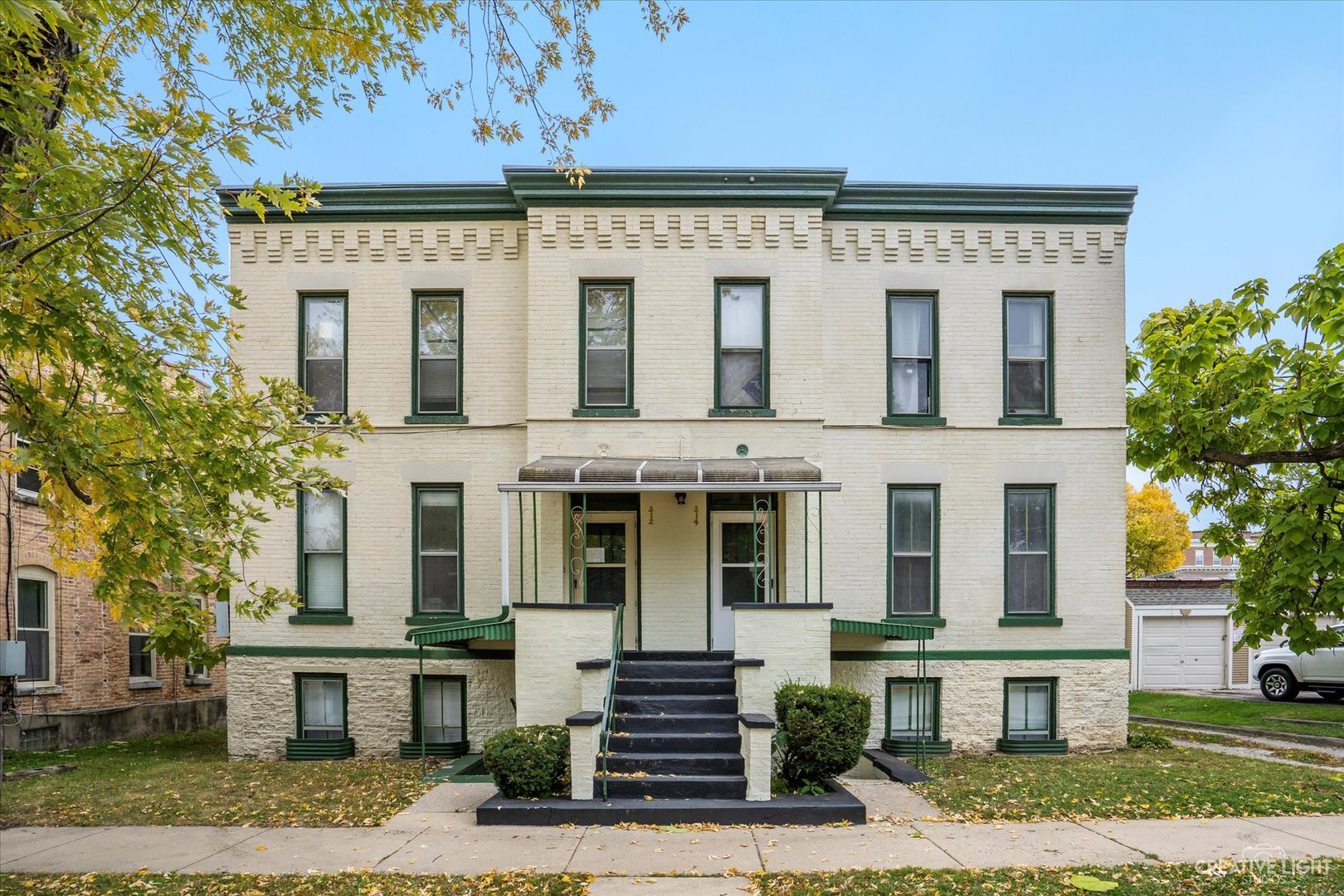 a front view of a residential apartment building with a yard