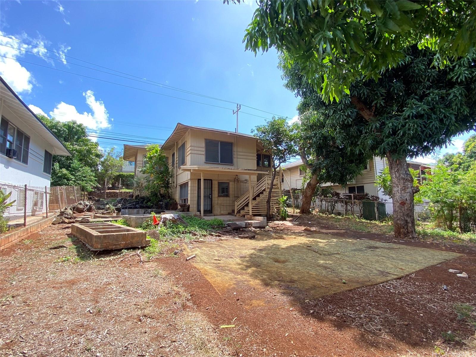 a backyard of a house with yard and outdoor seating