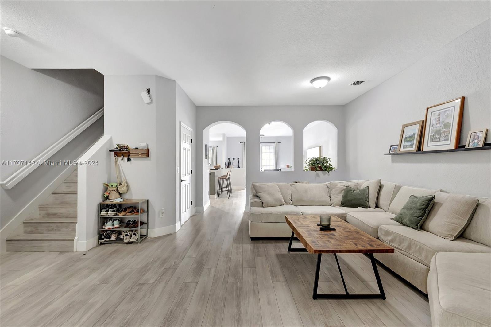 a living room with furniture and wooden floor