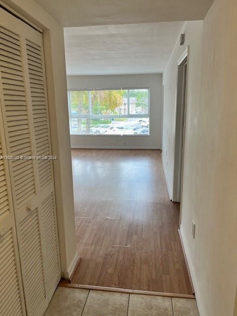 a view of a room with wooden floor and a window