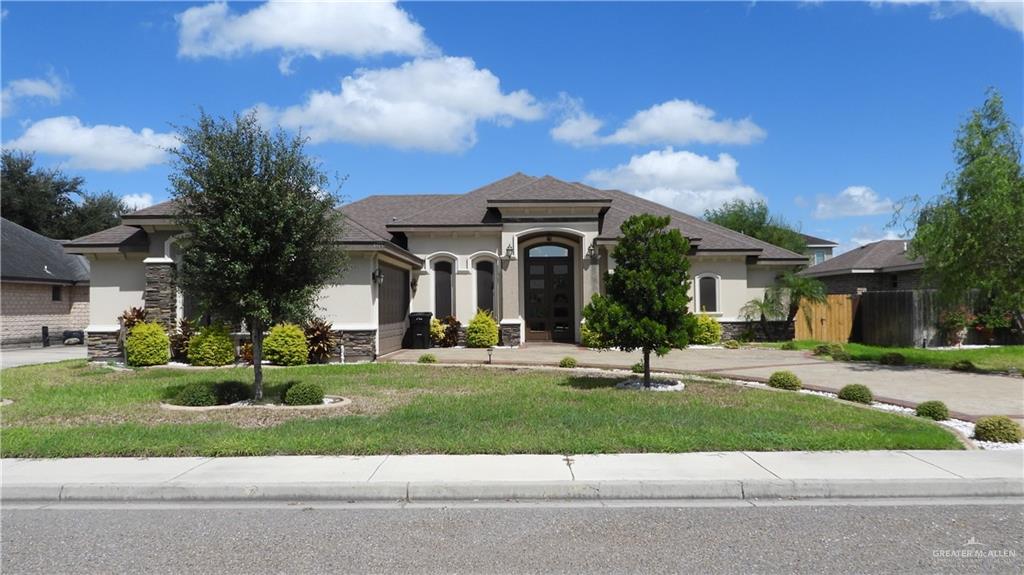 a front view of a house with a garden