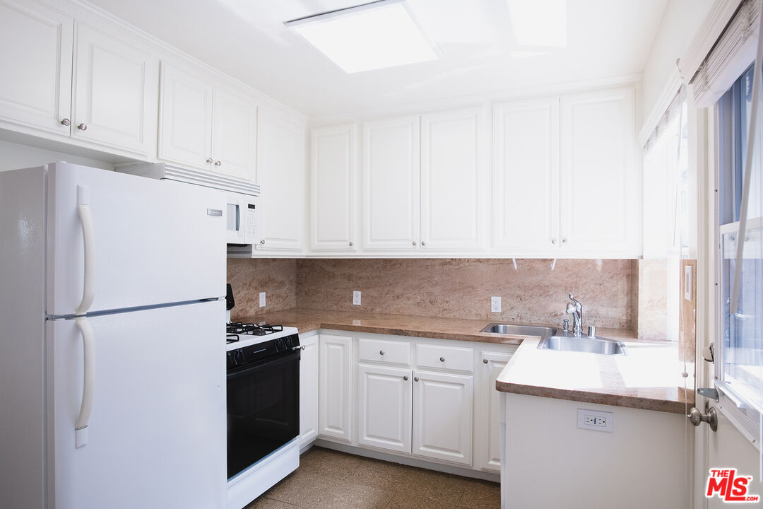 a white refrigerator freezer sitting in a kitchen