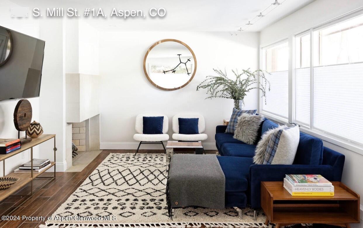 a living room with furniture a rug and a window