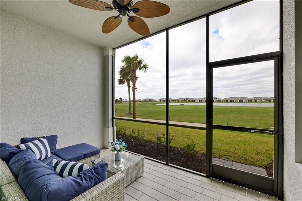 a living room with furniture and a floor to ceiling window