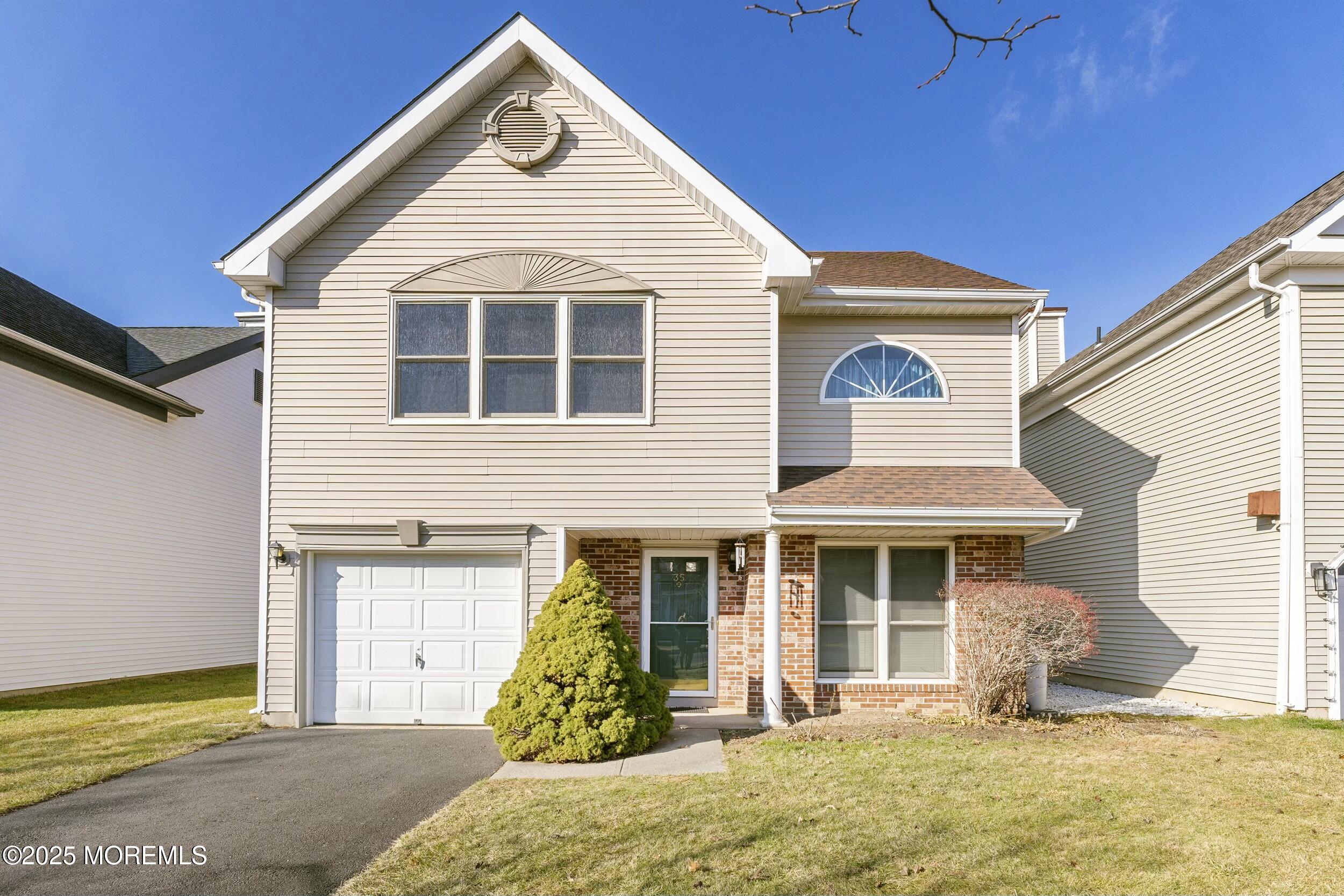 a front view of a house with a yard