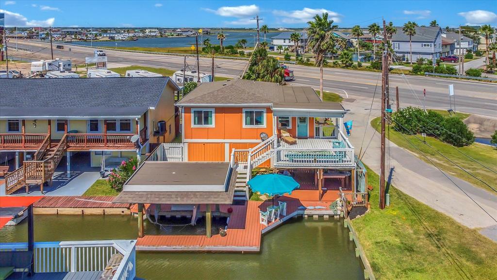 an aerial view of a house with swimming pool lawn chairs and a yard