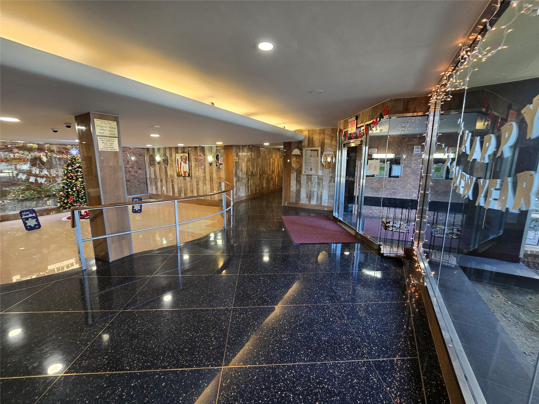 a view of a lobby with a couch and wooden floor